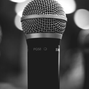 Monochrome close-up of a PG58 microphone, ideal for audio and music themes.